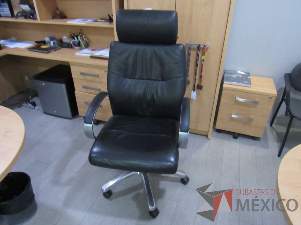 Lote 006 - Silla ejecutiva con ruedas, cabecera, descansabrazos, asiento y respaldo tipo piel color negro.