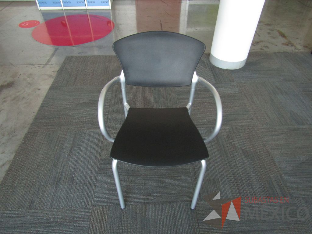 Lote 037 - Silla fija, descansabrazos fijo, asiento y respaldo en plástico color negro estructura metálica