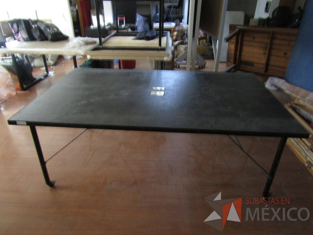 Lote 024 - Mesa de trabajo, estructura métalica con ruedas y cubierta color negro con 2 accesorios para conexión.