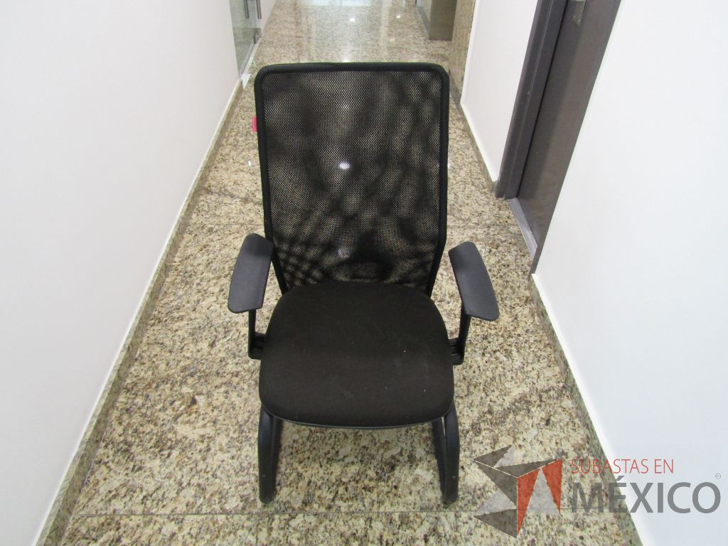 Lote 122 - Silla tipo trineo, descansabrazo fijo, asiento en tela color negro y respaldo en malla