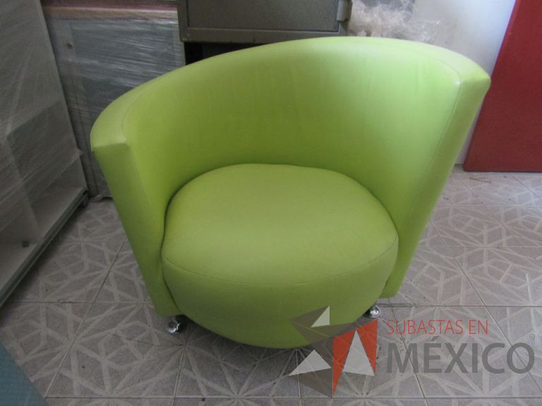 Lote 103 - Sillón tipo piel color verde, respaldo en forma curva, patas metálicas