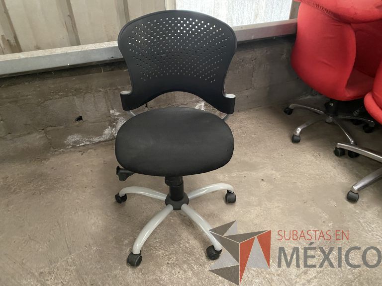 Lote 050 - Silla operativa con ruedas, sin descansabrazos, respaldo en plástico y asiento en tela color negro