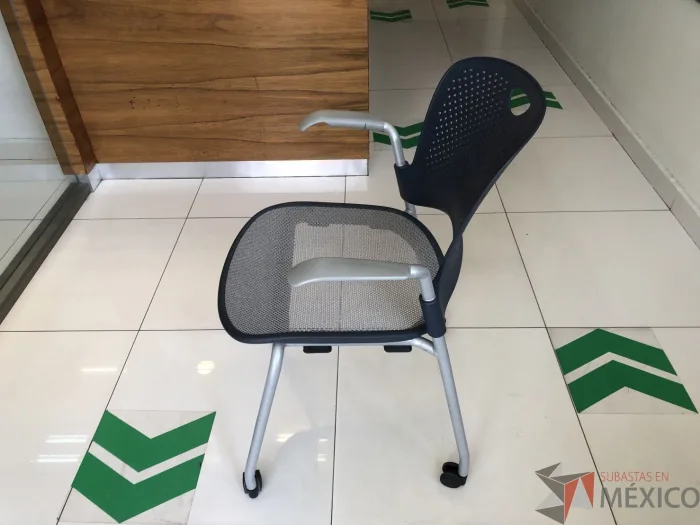 Lote 091 - Silla de visita con ruedas, descansabrazos, asiento en malla y respaldo en plástico color azul - Imagen 5